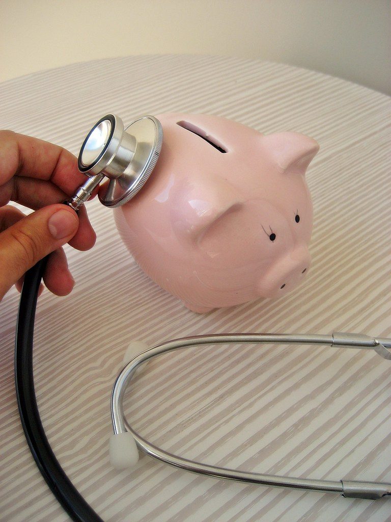 a piggy bank and a stethoscope, standing in for how an hsa as a retirement account grows untouched