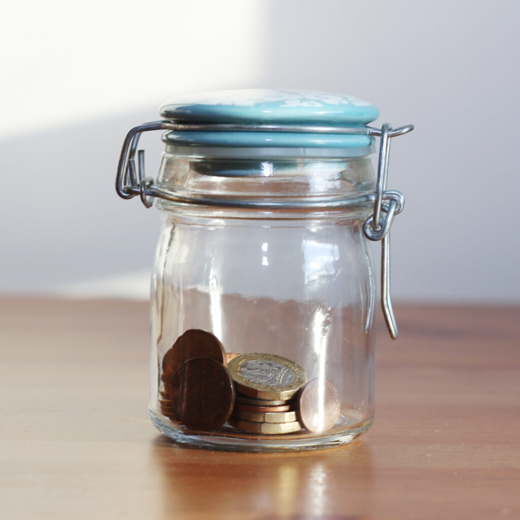 Jar of coins representing zero-based budgeting, where every dollar gets a job