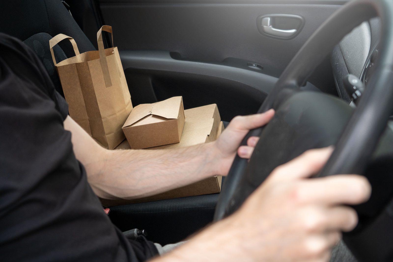 taxes for gig workers: a delivery driver with takeout orders and a steering wheel, representing 1099 income and self-employment tax
